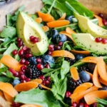 Wintery Greens with Avocado, Berries, Pistachios and Tahini Dressing